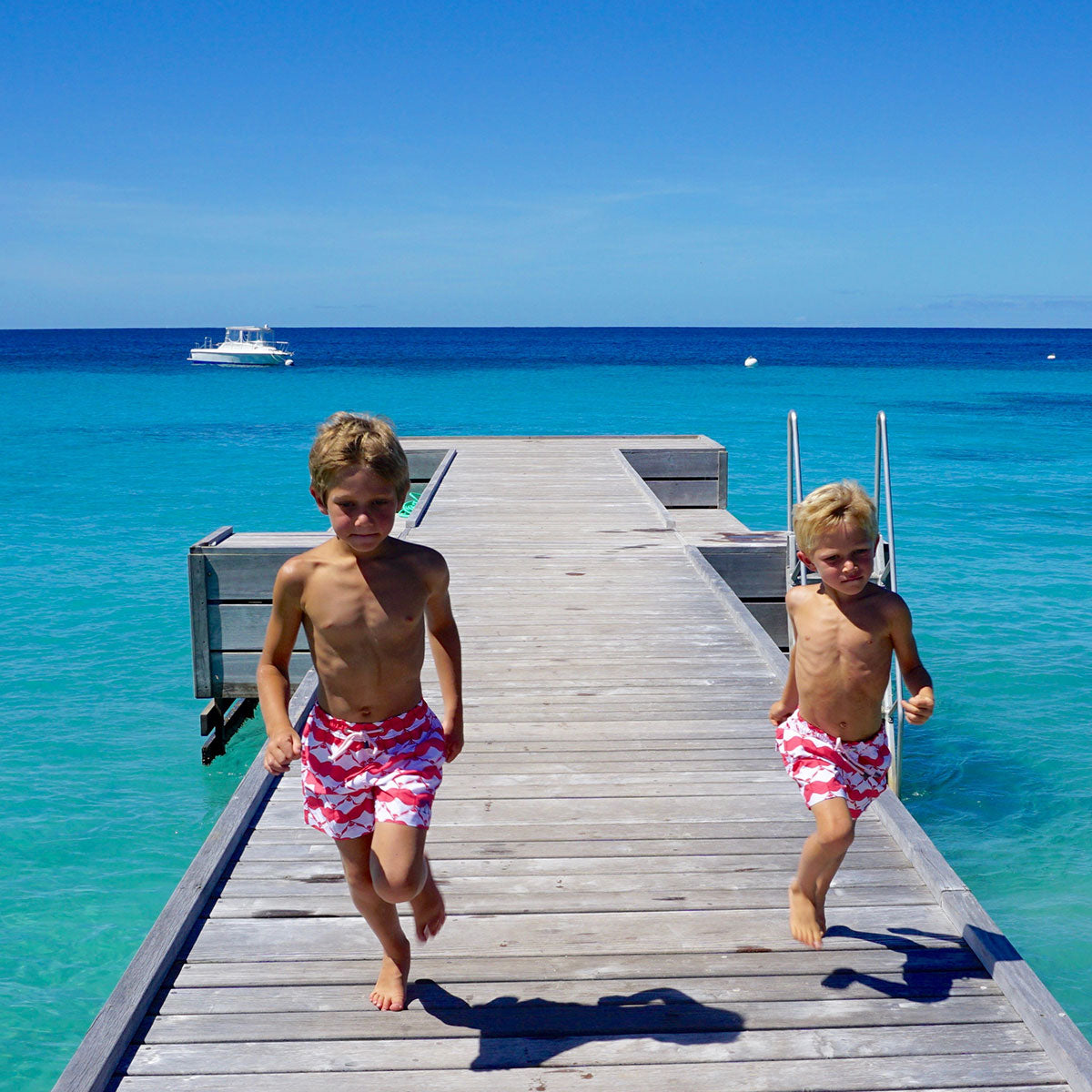 Boys swim trunks : MANTA RAY - RED running down the jetty Mustique