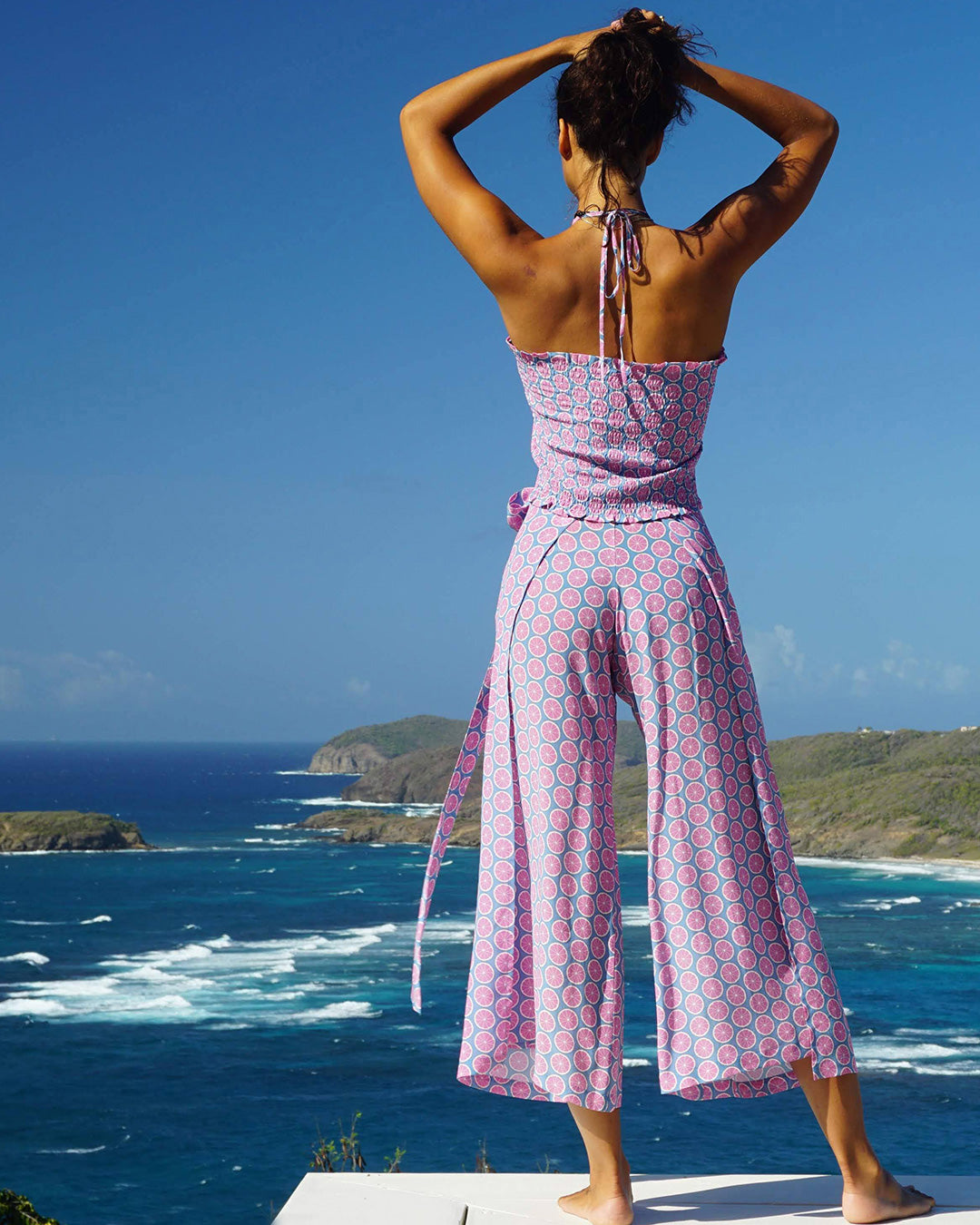 Chic vacation style pure silk shirred bandeau top in Lime Slice blue and pink print with matching Gabija palazzo pants by designer Lotty B Mustique