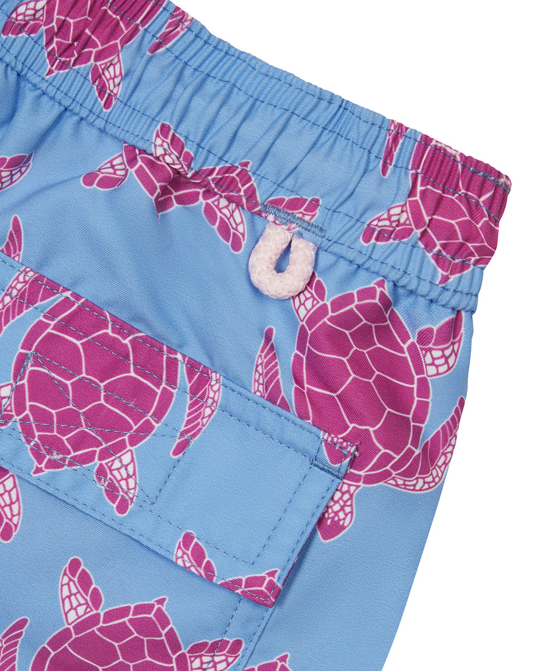 Back pocket detail of kids blue and pink Turtle swim shorts in repreve recycled polyester mix by Lotty B for Pink House