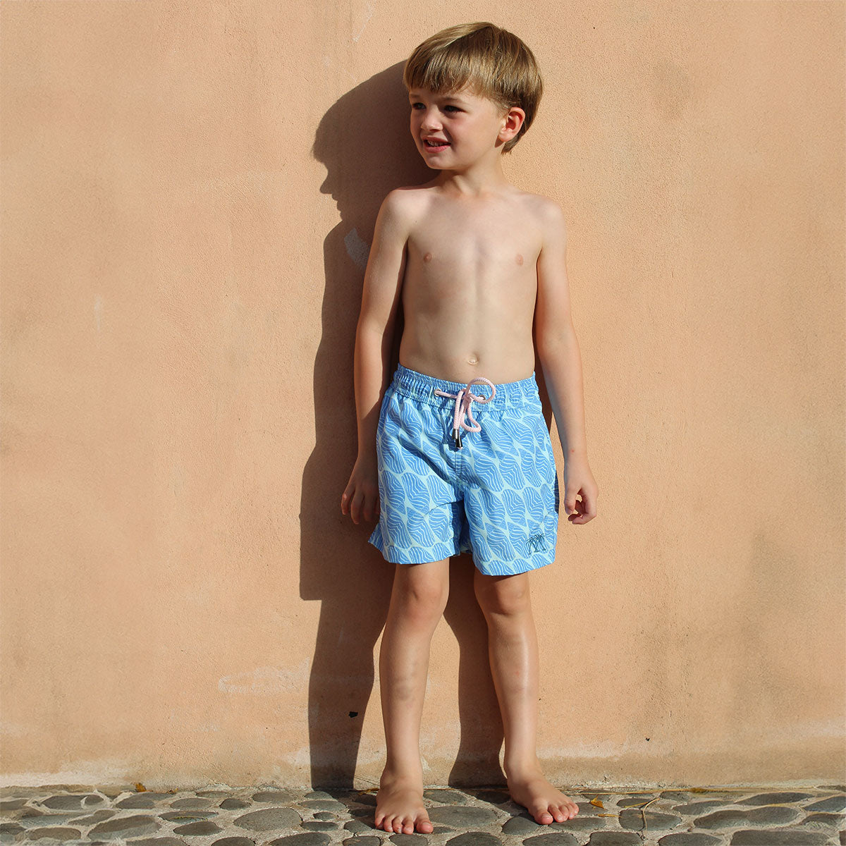 Boys villa vacation swim shorts in blue Striped Shell print by designer Lotty B