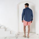 Men's holiday swim trunks in coral pink Striped Shell print by designer Lotty B