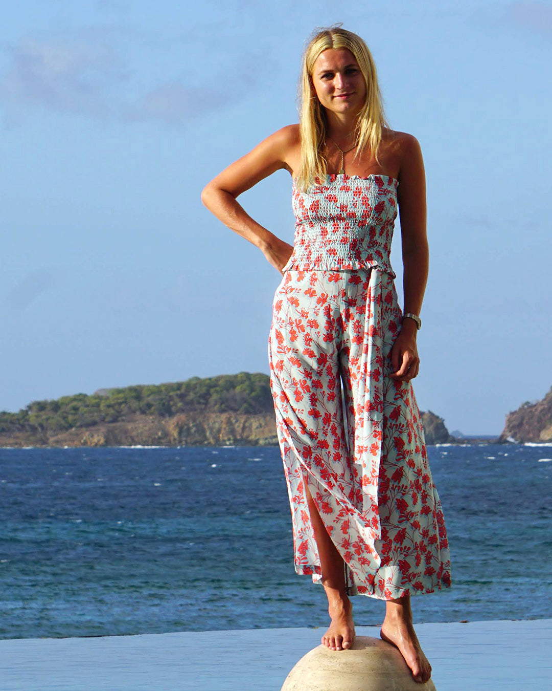 Island vacation silk shirred bandeau top in pale blue and orange floral Flamboyant Flower print with matching palazzo pants by designer Lotty B Mustique