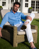 Easy to wear stretch linen pants worn with French blue linen shirt. Designer linens by Pink House 