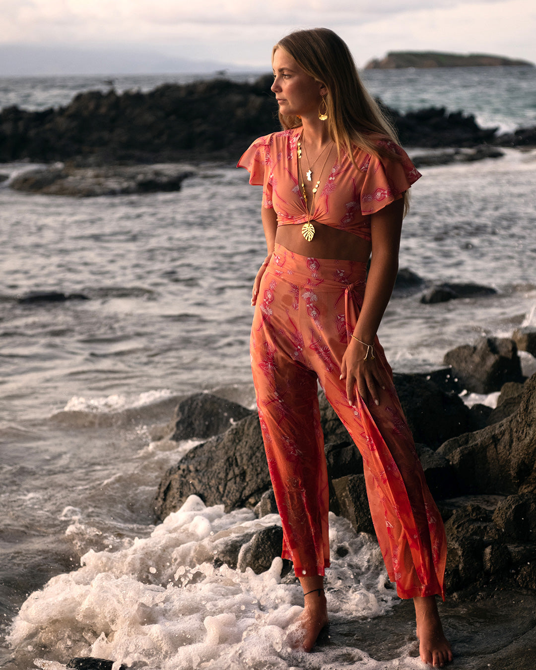 Beach vacation occasionwear Lyla crop top in Fruit Punch pink and orange print worn with matching palazzo pants by designer Lotty B for Pink House